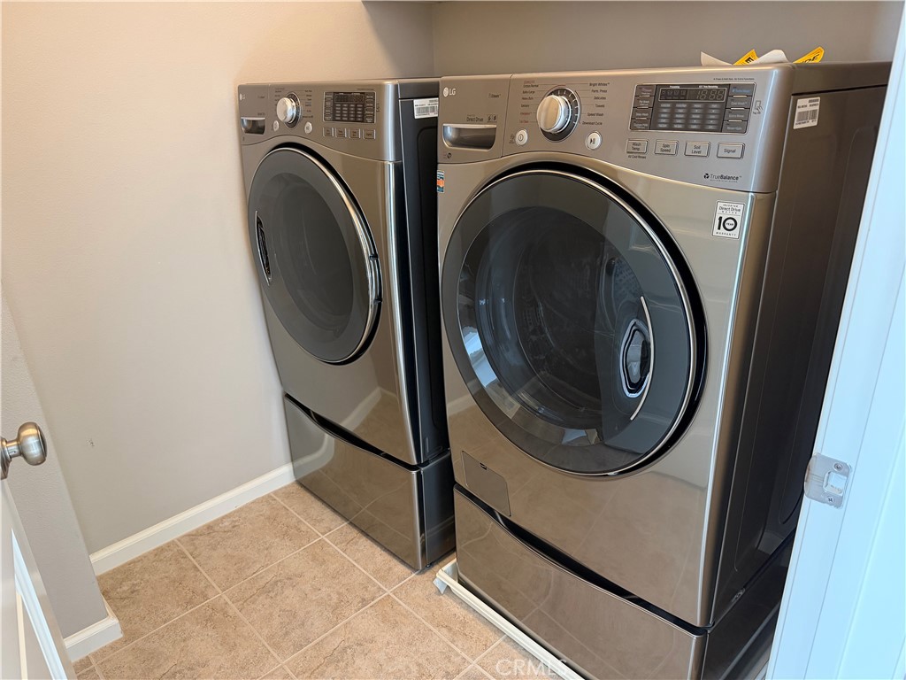 56 Strawberry Grove Irvine, CA 92620 - Photo 14 of 24 a utility room with dryer and washer