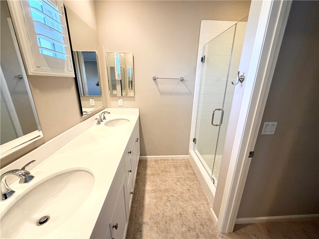 56 Strawberry Grove Irvine, CA 92620 - Photo 19 of 24 a bathroom with a tub sink and mirror