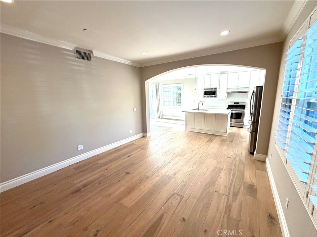 56 Strawberry Grove Irvine, CA 92620 - Photo 6 of 24 an entryway with wooden floor and a window