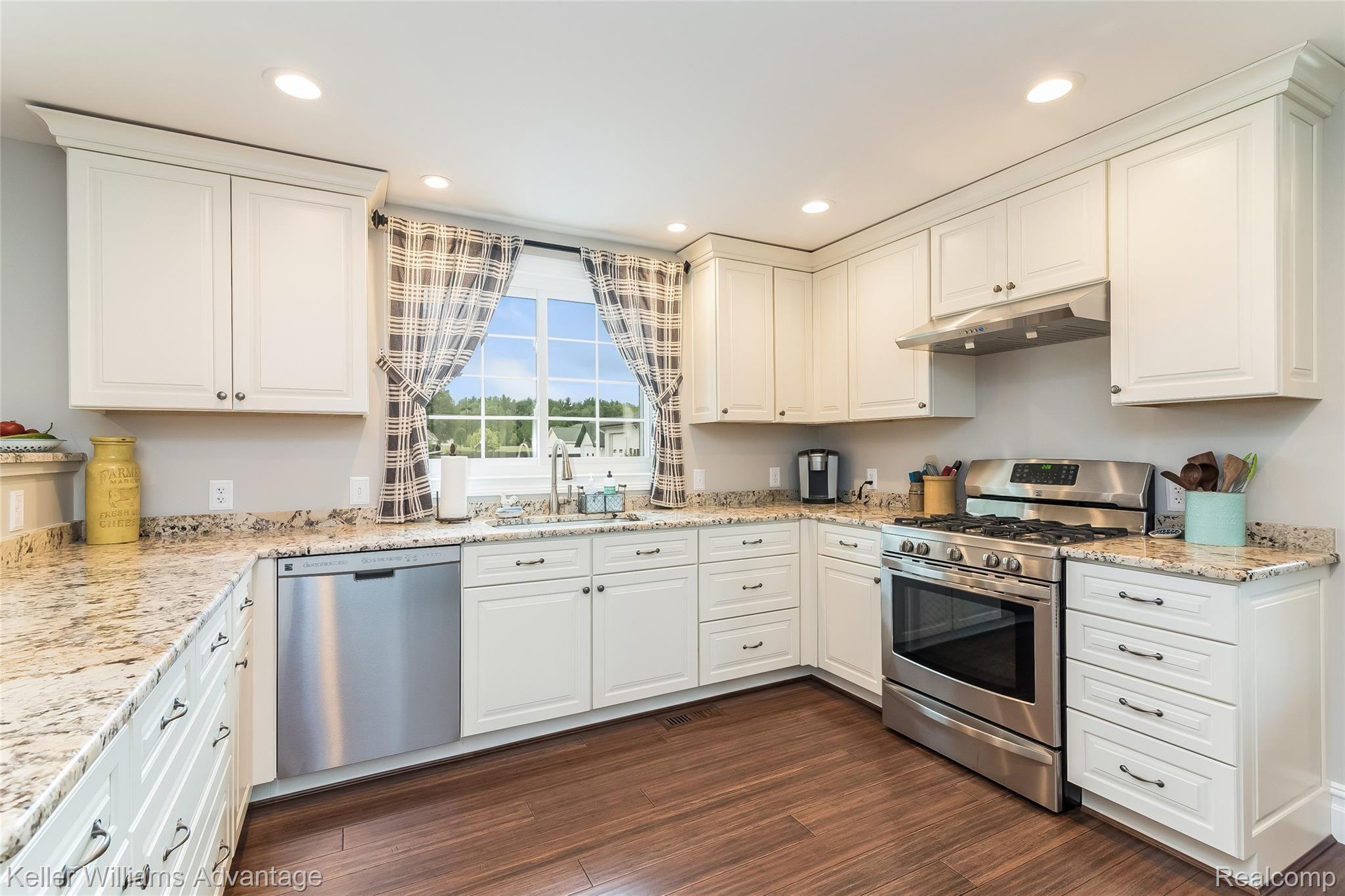 5385 Mack Road Howell, MI 48855 - Photo 6 of 59 Kitchen with new granite counters, eat-in-counter seating, stainless steel appliances, gas range. Dura Supreme cabinetry with soft-close doors. Overlooking back of home, open to breakfast nook and dining area.