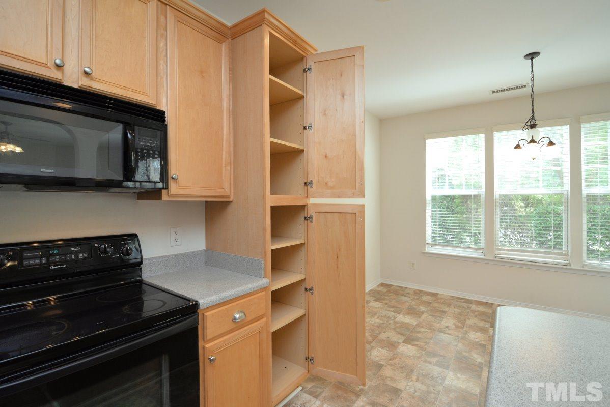 8303 Rubblestone Path Raleigh, NC 27613 - Photo 13 of 25 a kitchen with a stove and a microwave