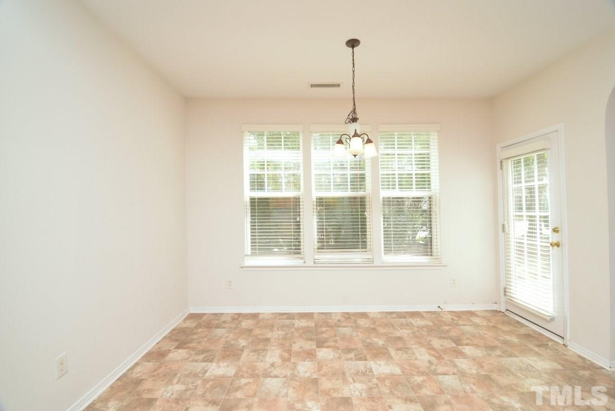 8303 Rubblestone Path Raleigh, NC 27613 - Photo 14 of 25 a view of an empty room with a window