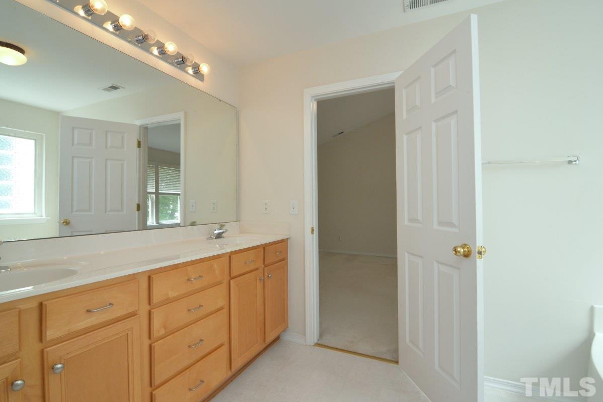 8303 Rubblestone Path Raleigh, NC 27613 - Photo 17 of 25 a bathroom with a granite countertop sink mirror and double