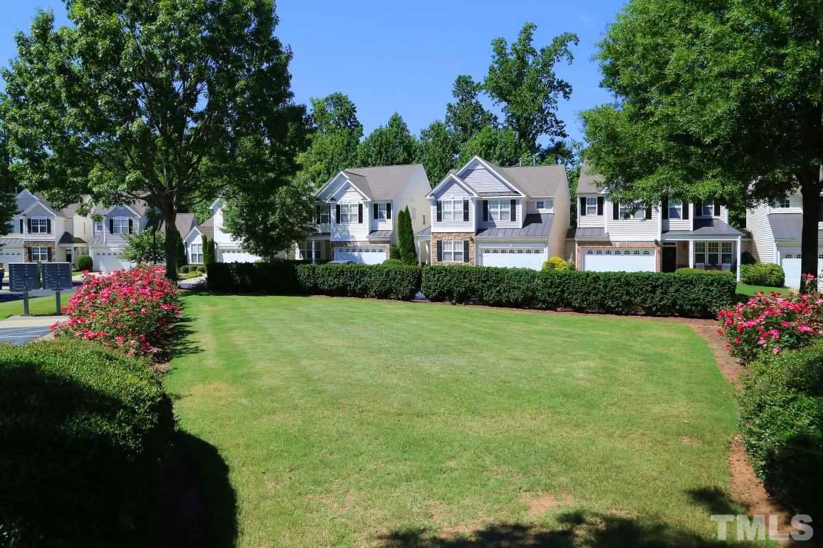 8303 Rubblestone Path Raleigh, NC 27613 - Photo 3 of 25 a front view of a house with a yard and garage