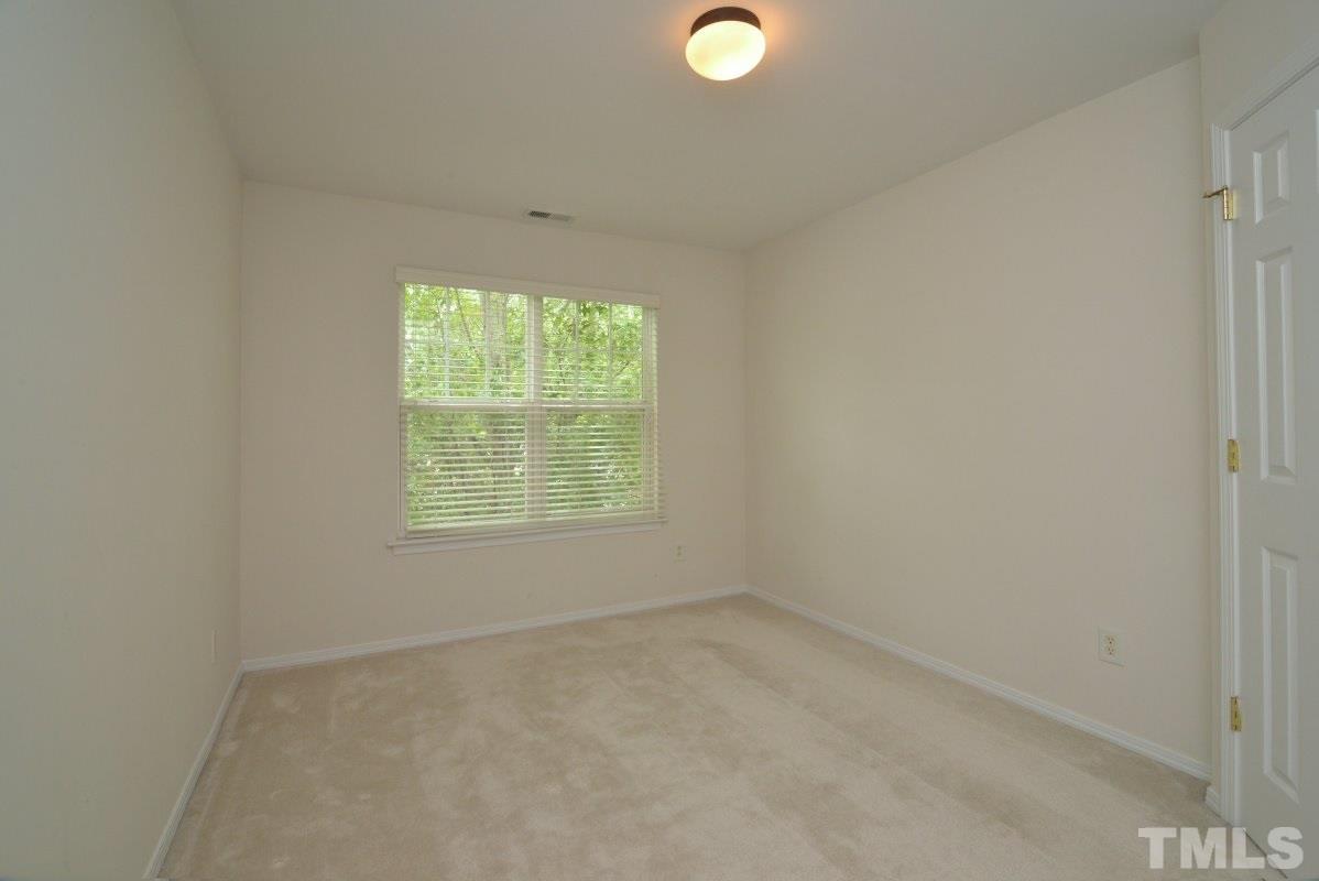 8303 Rubblestone Path Raleigh, NC 27613 - Photo 21 of 25 an empty room with a window
