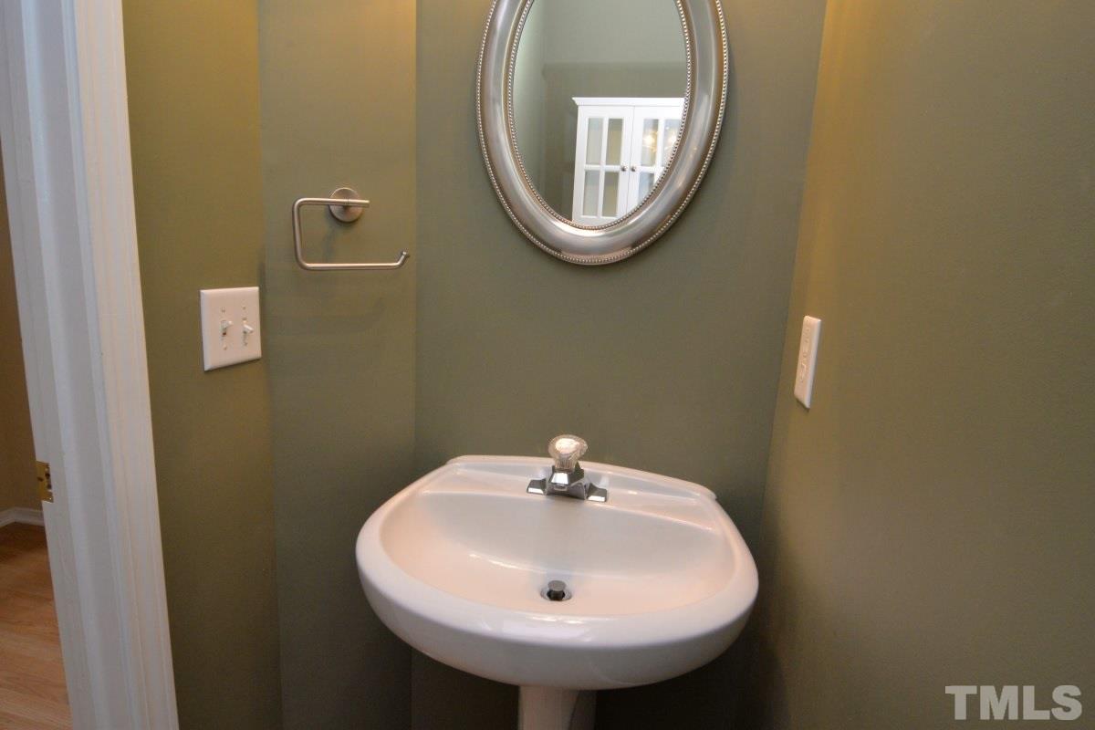 8303 Rubblestone Path Raleigh, NC 27613 - Photo 23 of 25 a bathroom with a sink and a mirror