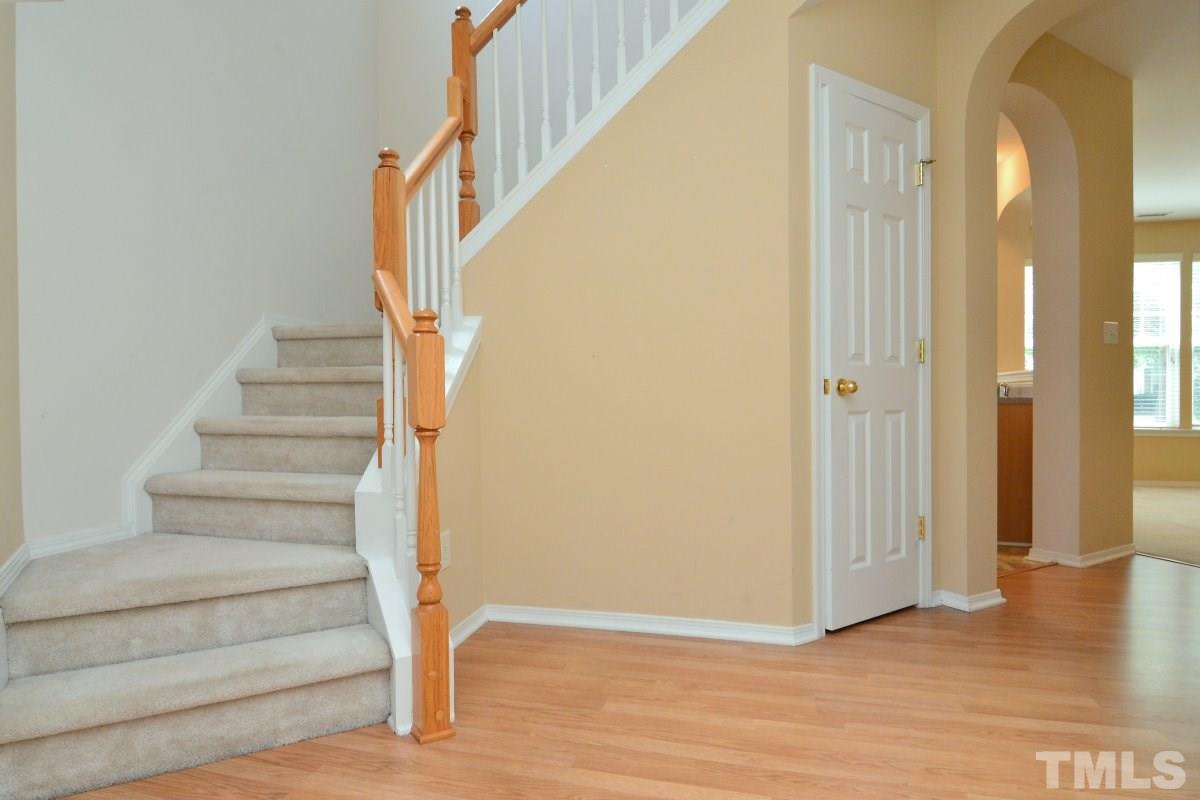8303 Rubblestone Path Raleigh, NC 27613 - Photo 5 of 25 a view of entryway and hall with wooden floor