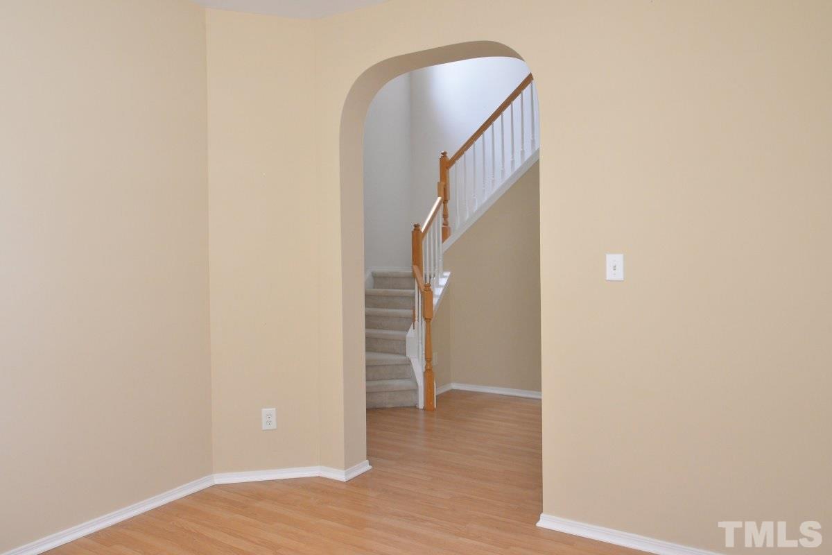 8303 Rubblestone Path Raleigh, NC 27613 - Photo 7 of 25 a view of a room with wooden floor and entryway