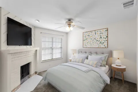 a bedroom with a large bed and a flat screen tv