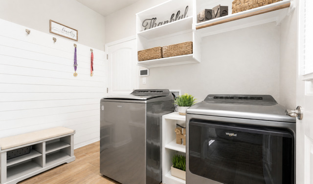 1928 Lakeside Ranch Road Georgetown, TX 78633 - Photo 12 of 37 A well-organized laundry room with natural wood flooring and practical storage solutions.