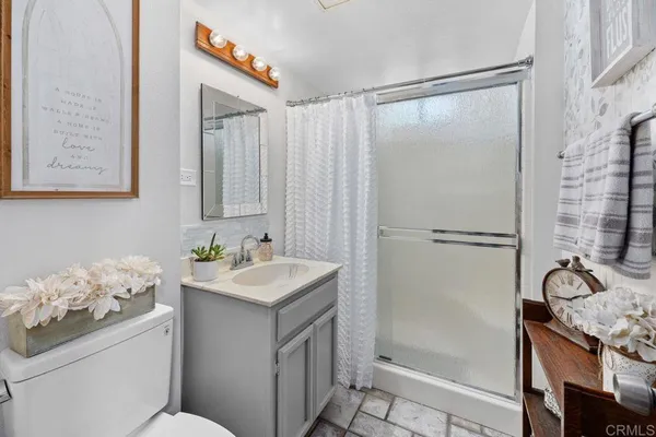 a bathroom with a sink toilet and shower
