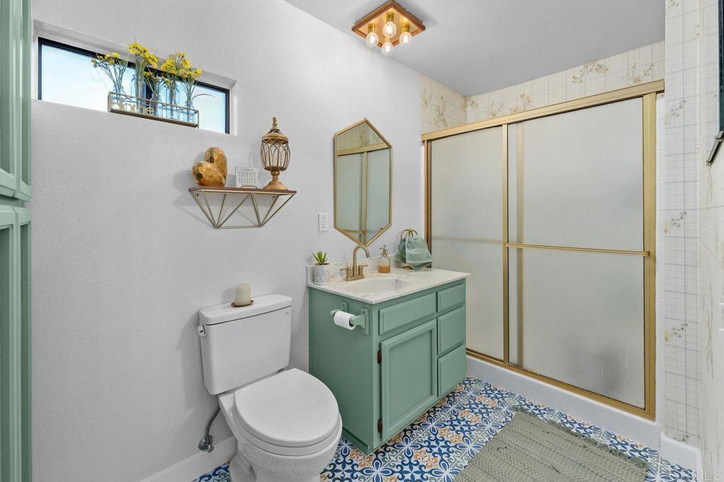 2869 Polk Road Alpine, CA 91901 - Photo 16 of 36 a bathroom with a toilet sink and mirror