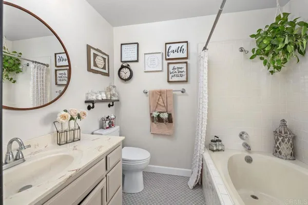 a bathroom with a sink mirror vanity and toilet