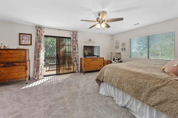 a spacious bedroom with a bed and a walk in closet