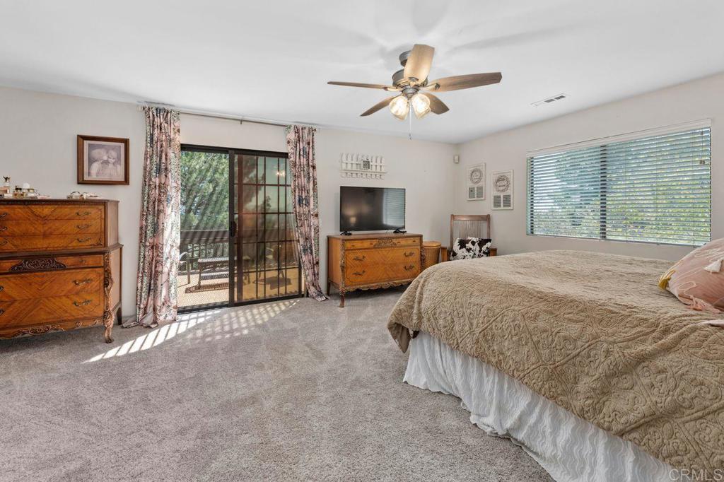 2869 Polk Road Alpine, CA 91901 - Photo 19 of 36 a spacious bedroom with a bed and a walk in closet