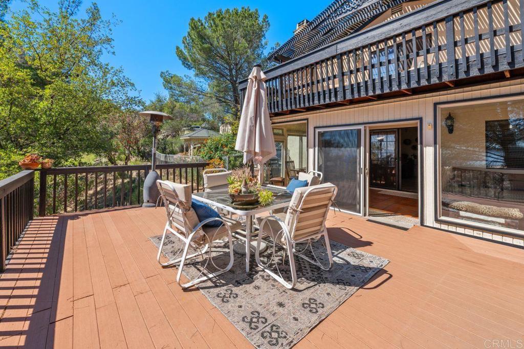 2869 Polk Road Alpine, CA 91901 - Photo 21 of 36 a view of a patio with table and chairs with wooden floor and fence