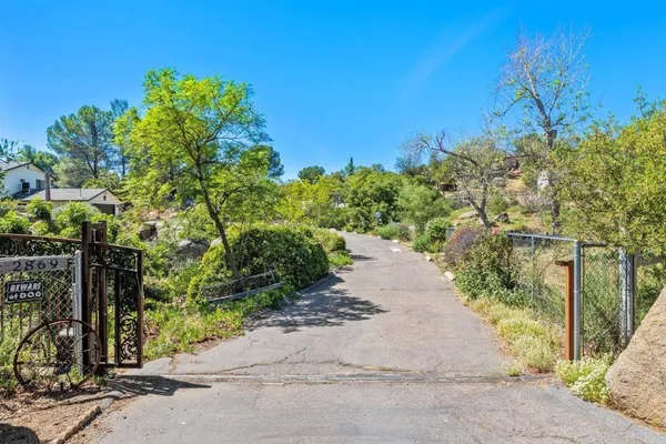 a view of a fence and trees all around