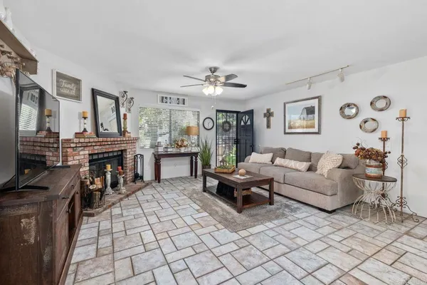 a living room with furniture a fireplace and a flat screen tv