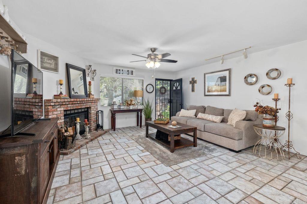 2869 Polk Road Alpine, CA 91901 - Photo 7 of 36 a living room with furniture a fireplace and a flat screen tv