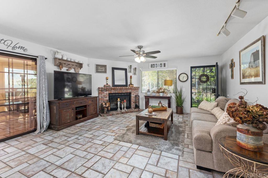 2869 Polk Road Alpine, CA 91901 - Photo 8 of 36 a living room with furniture a flat screen tv and a fireplace