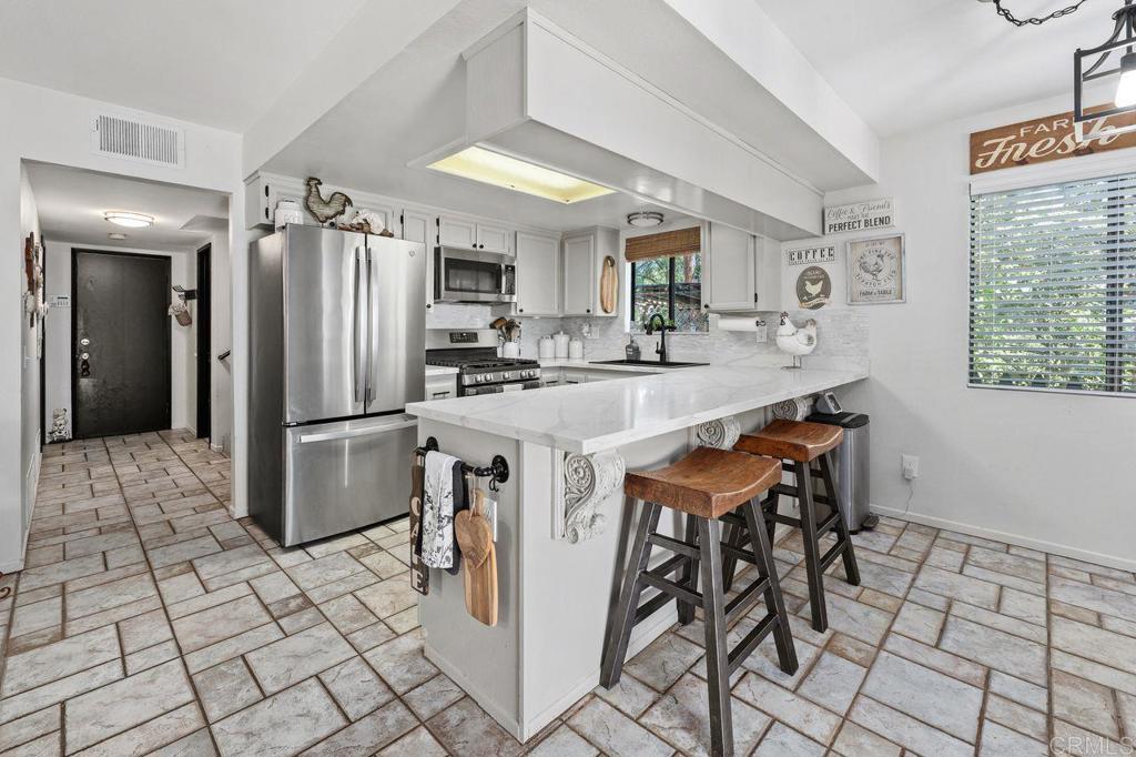 2869 Polk Road Alpine, CA 91901 - Photo 10 of 36 a kitchen with stainless steel appliances granite countertop a sink and a refrigerator