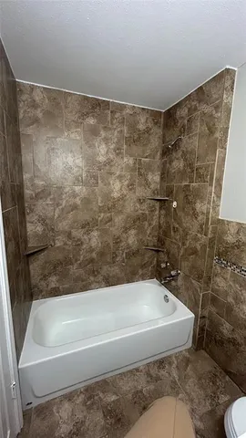 a bathroom with a bathtub and shower