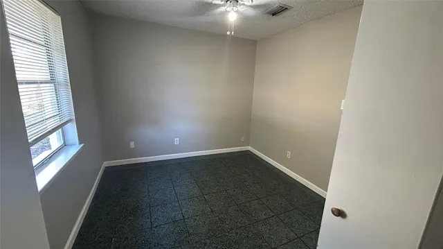 an empty room with windows and entrance