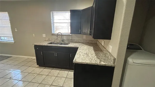 a room with granite countertop a sink a vanity and window