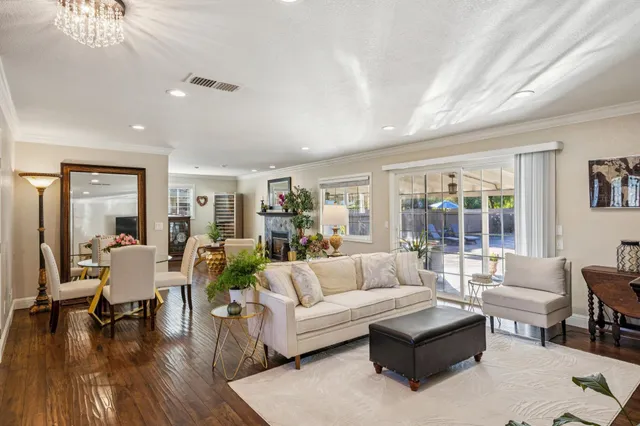 a dining room with furniture window and wooden floor