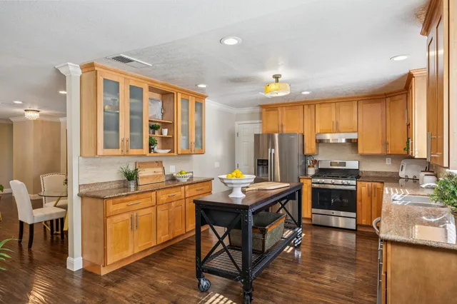 a kitchen with a sink appliances and cabinets