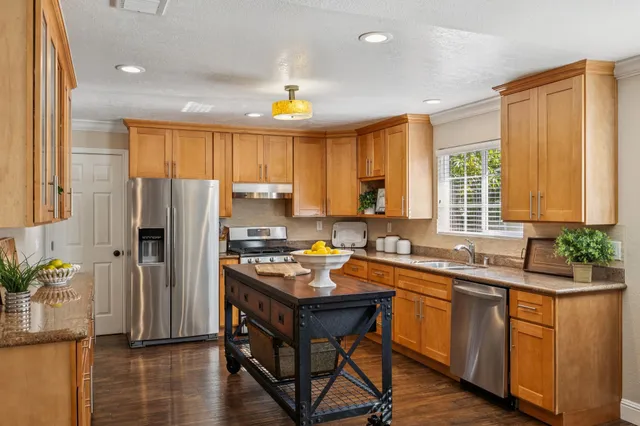 a bathroom with a granite countertop sink and a window