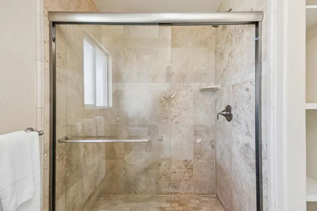 a bedroom with a large bed and a large window