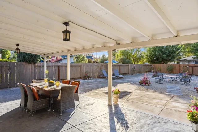 a view of backyard with swimming pool and furniture