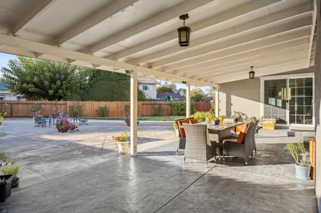 a view of a chairs and table in the backyard