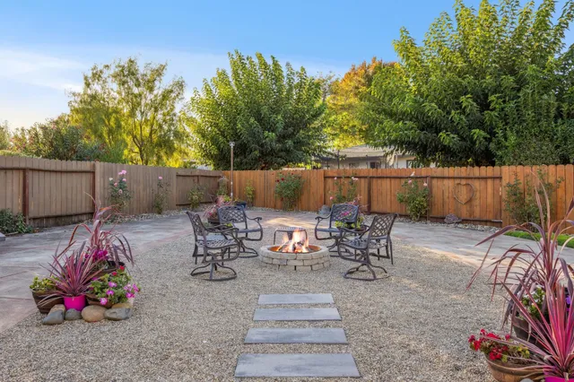 a front view of a house with swimming pool and furniture
