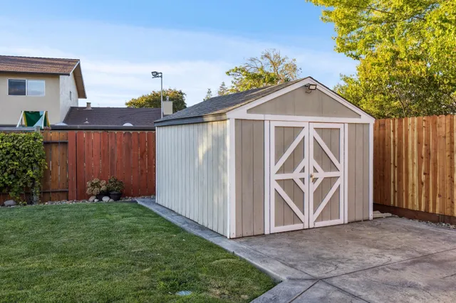 a view of an outdoor dining space with a table and chairs