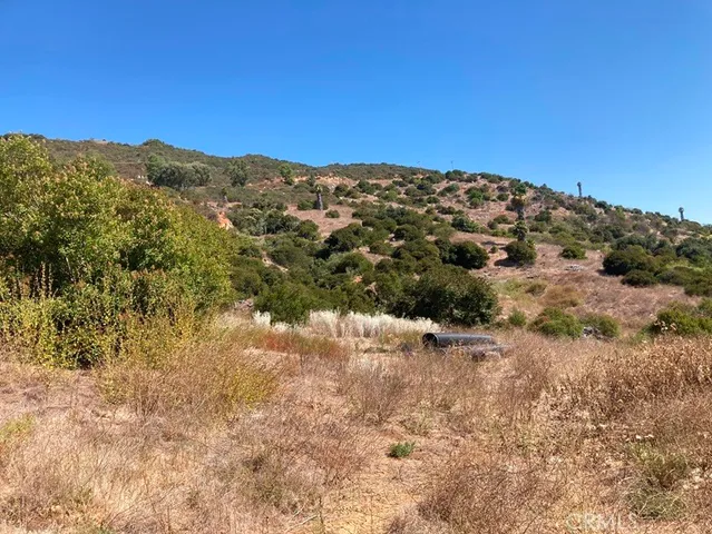 a view of a large building with mountains in the background
