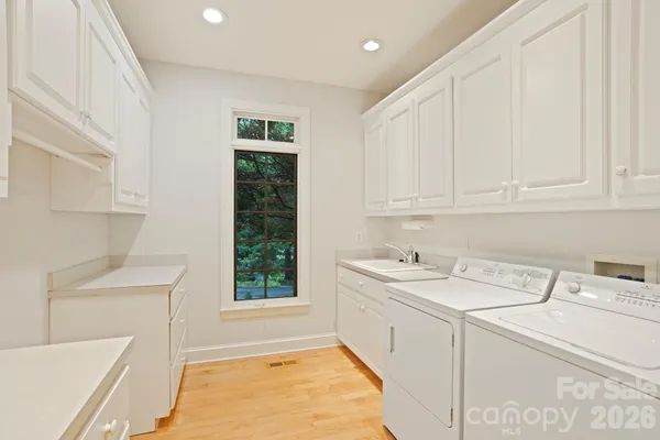 a room with a sink a vanity and window