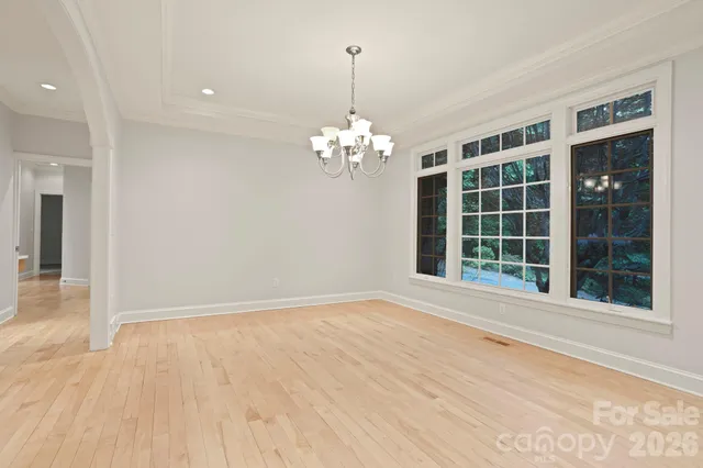 a view of a room with windows and chandelier