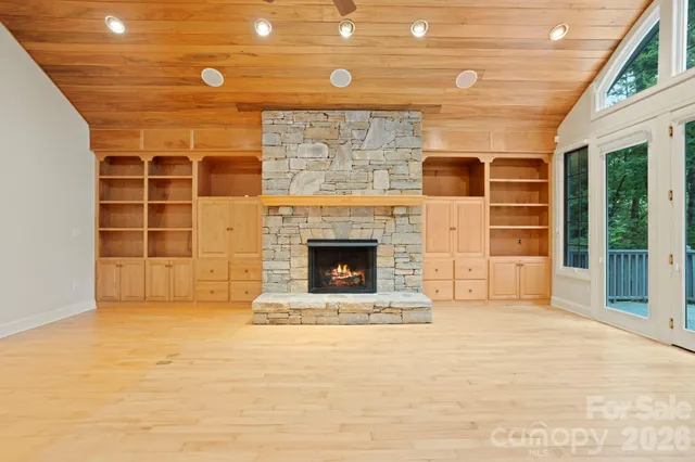 a view of an empty room with a fireplace and a window