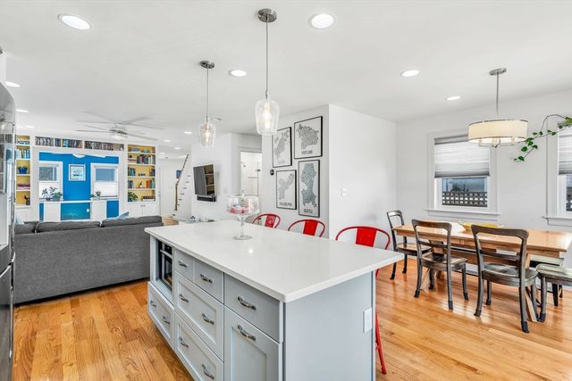 a very nice looking kitchen with a large center island and some windows