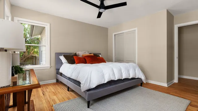 a bed sitting in a bedroom next to a window