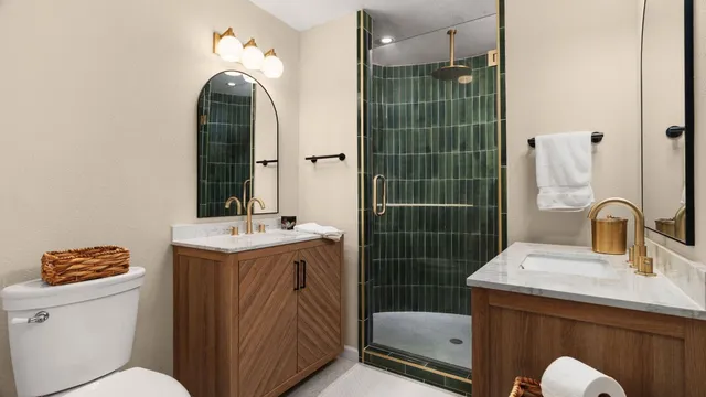 a bathroom with a sink a toilet and shower