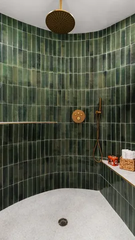 a bathroom with a blue tub and a shower