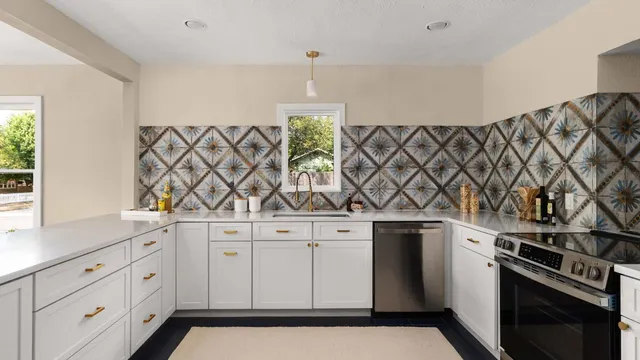 a kitchen with stainless steel appliances a sink and a stove