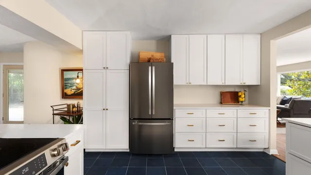 a kitchen with a refrigerator and cabinets