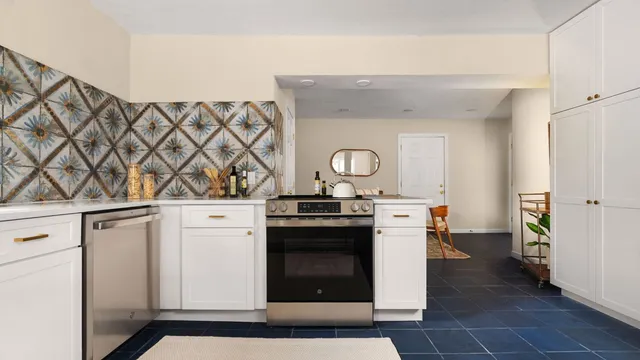a stove top oven sitting inside of a kitchen