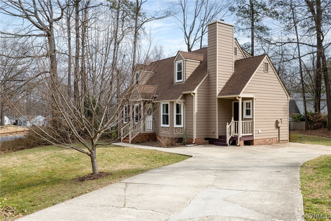 2617 Iverson Road Midlothian, VA 23112 - Photo 4 of 32 a view of a white house with a large tree