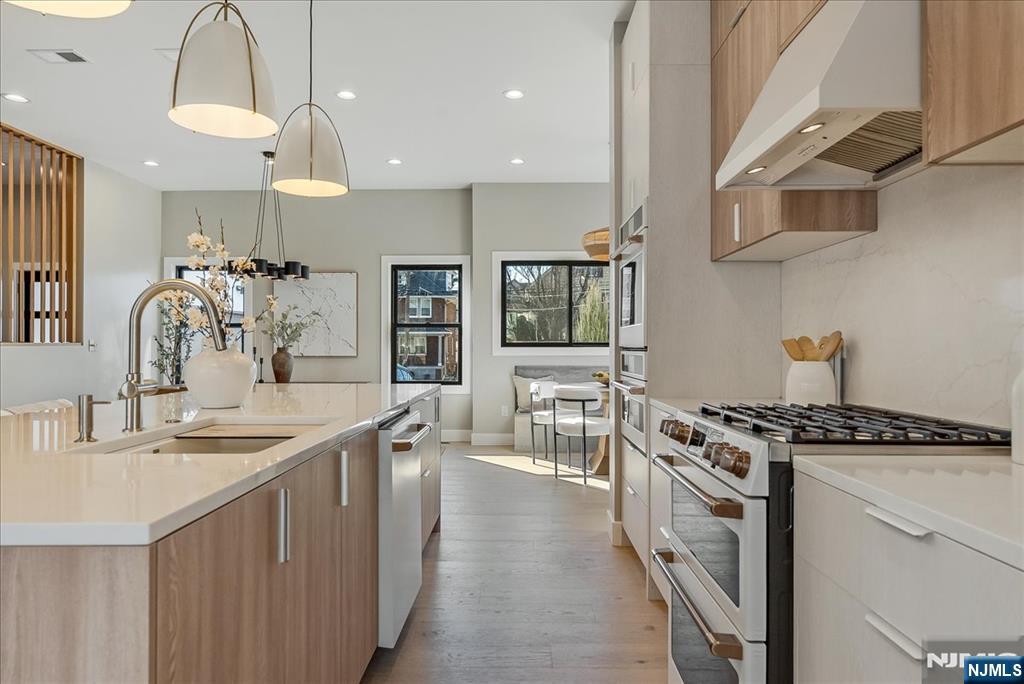 36 James Street Montclair, NJ 07042 - Photo 12 of 48 a kitchen with stainless steel appliances a sink stove and cabinets