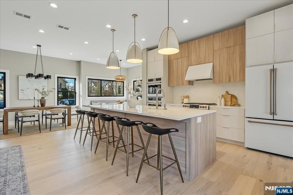 36 James Street Montclair, NJ 07042 - Photo 13 of 48 a kitchen with stainless steel appliances kitchen island granite countertop a stove a sink a oven a dining table and chairs